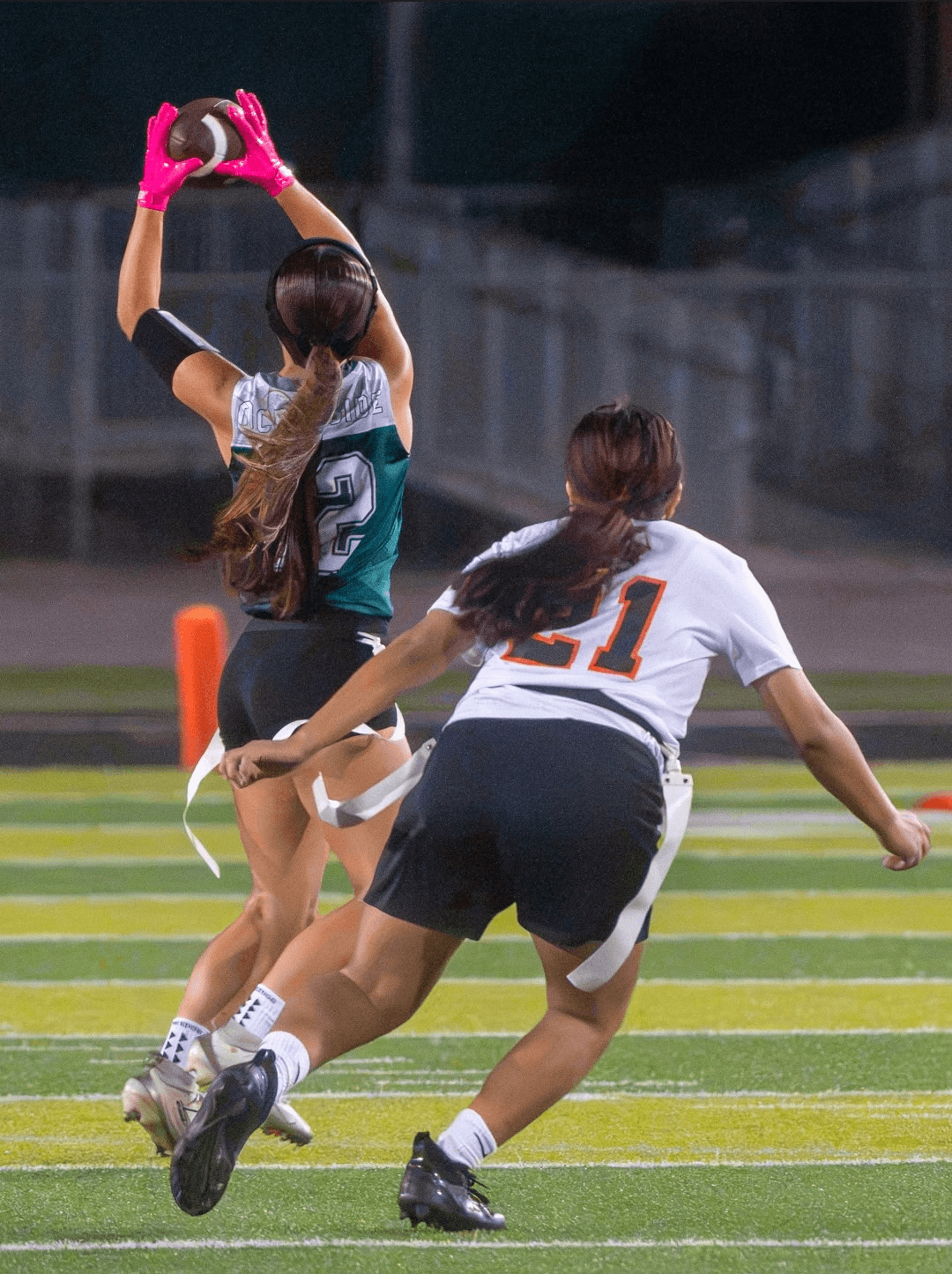 Flag football player reaching to catch a pass