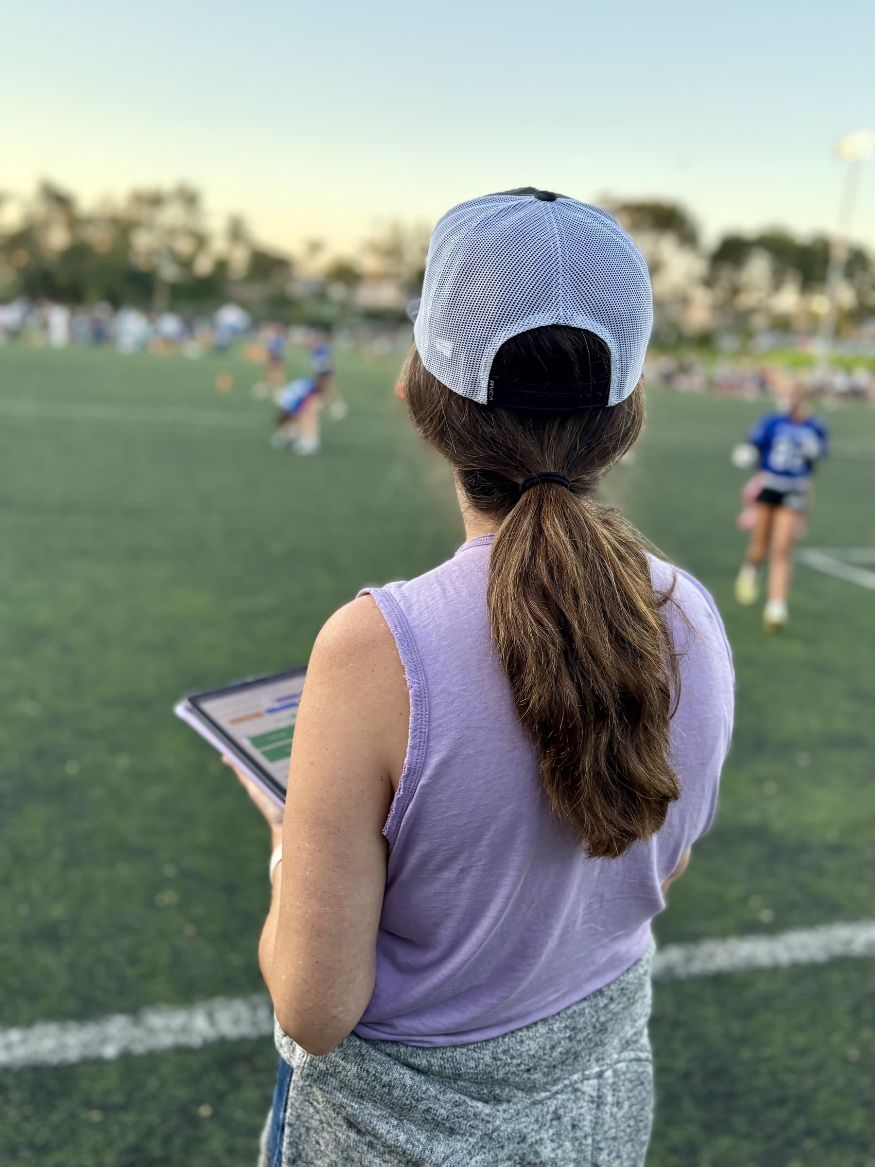 Statistician tracking live stats from the sideline
