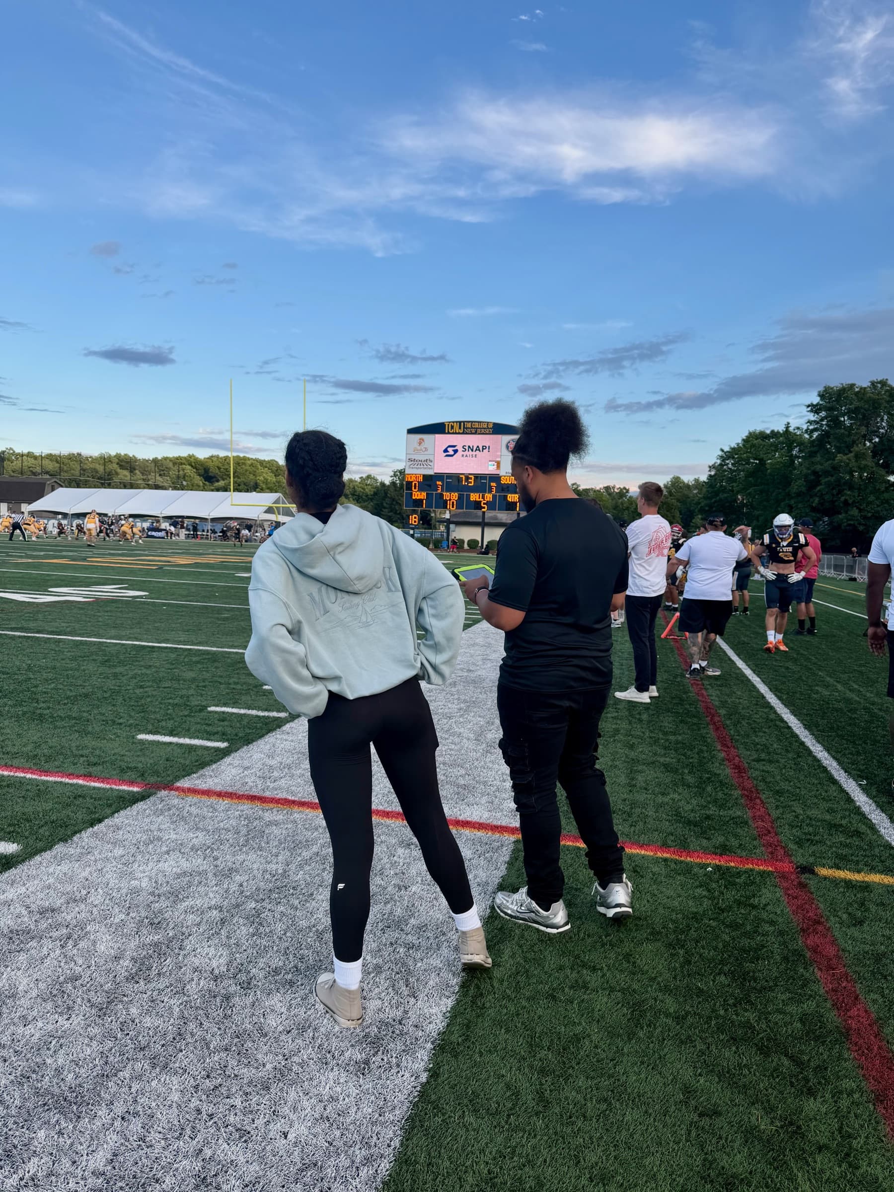 Players and coaches walking along the field