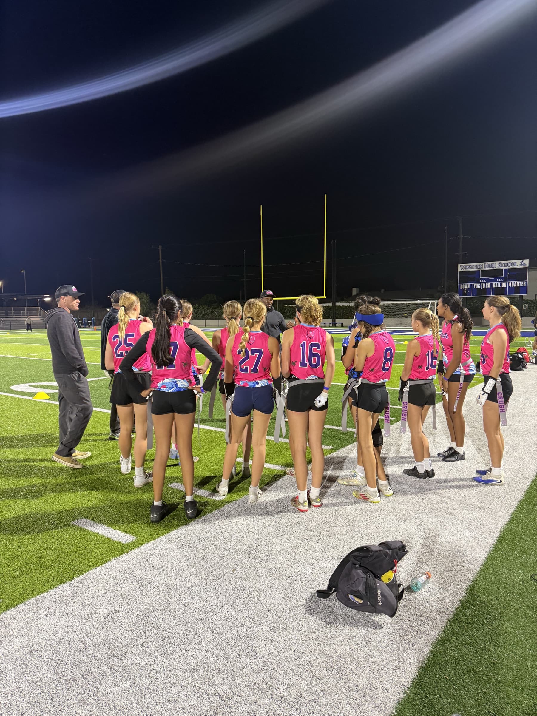 Team lined up on the field at night