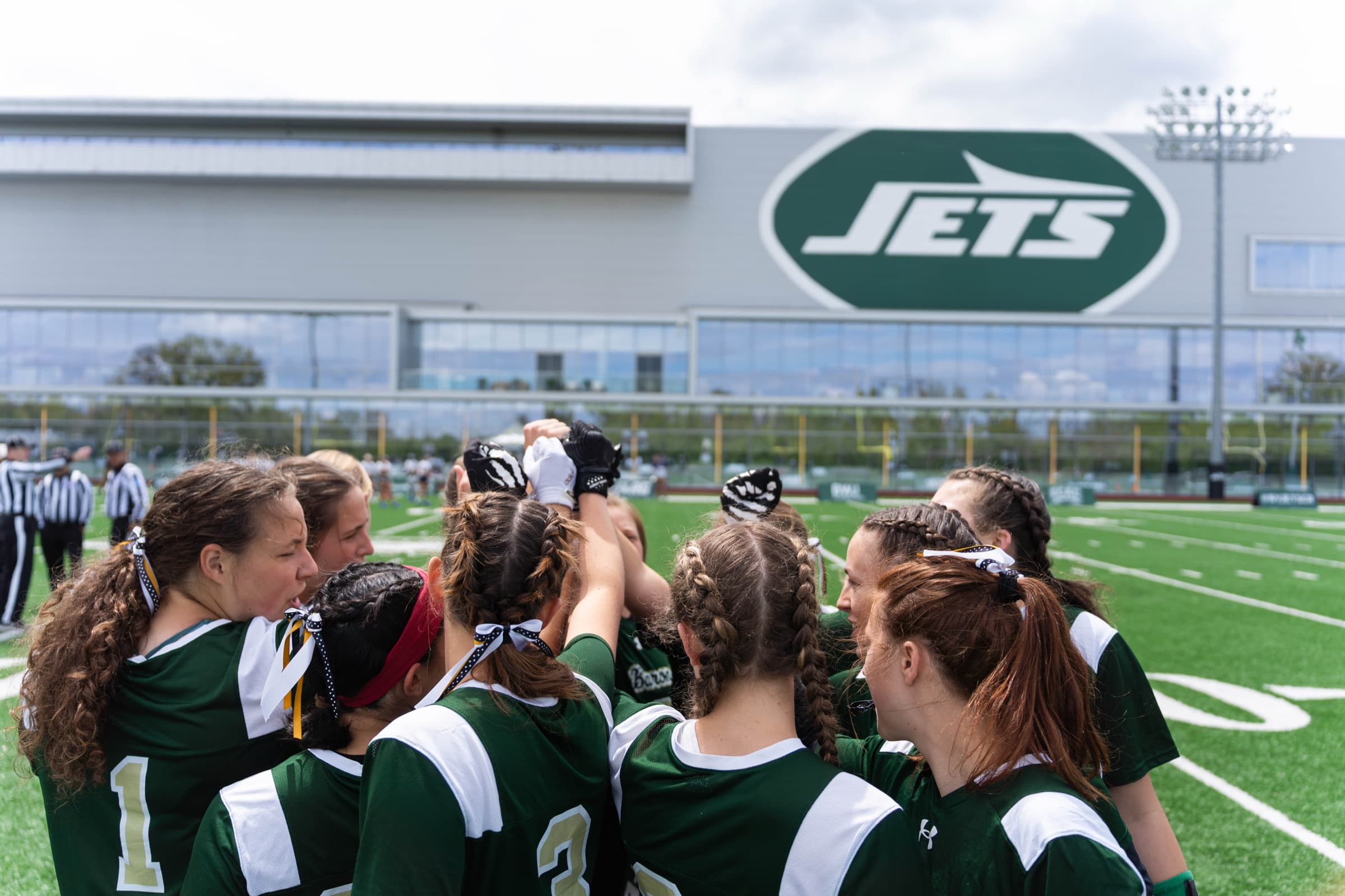 ECAC Jets players huddled on the field